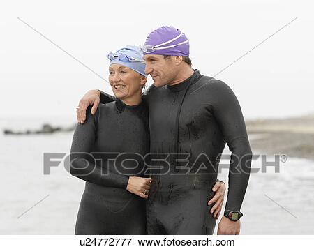 Divers smiling together on beach View Large Photo Image Stock Photo - Divers smiling together on beach. Fotosearch
