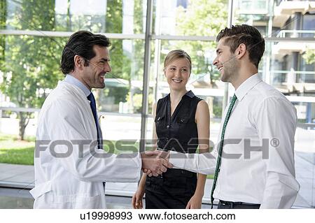 Doctor and businessman shaking hands View Large Photo Image Stock Image - Doctor and businessman shaking hands. Fotosearch