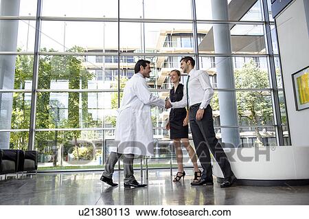 Doctor and businessman shaking hands View Large Photo Image Stock Image - Doctor and businessman shaking hands. Fotosearch