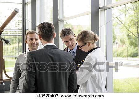 Stock Photo - Doctor and businessmen talking. Fotosearch