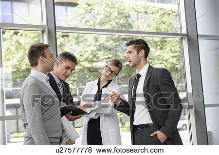 Stock Photo - Doctor and businessmen talking. Fotosearch