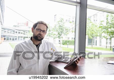 Doctor using tablet computer in office View Large Photo Image Stock Image - Doctor using tablet computer in office. Fotosearch
