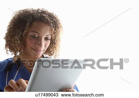 Stock Image - Doctor using tablet computer. Fotosearch