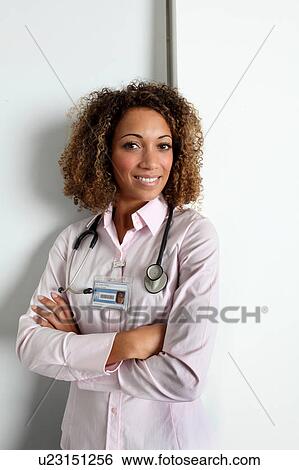 Stock Photograph - Doctor wearing stethoscope in hospital. Fotosearch