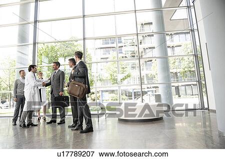 Stock Photo - Doctors and businessmen meeting. Fotosearch