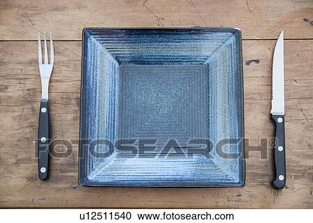 Empty plate, knife and fork on table View Large Photo Image Stock Image - Empty plate, knife and fork on table. Fotosearch