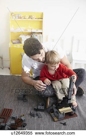 Stock Photography - Father and son building with blocks. Fotosearch