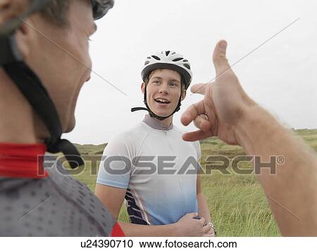 Father and son talking on rural road View Large Photo Image Stock Image - Father and son talking on rural road. Fotosearch