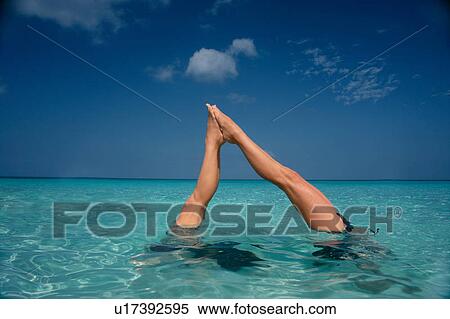 Stock Photography - Feet touching in tropical water. Fotosearch