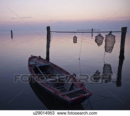 Fishing boat with nets in still water View Large Photo Image Stock Image - Fishing boat with nets in still water. Fotosearch