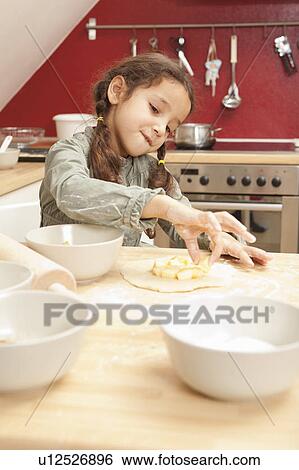 Stock Photograph - Girl baking in kitchen. Fotosearch