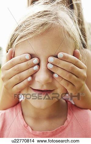 Girl covering friends eyes View Large Photo Image Picture - Girl covering friends eyes. Fotosearch