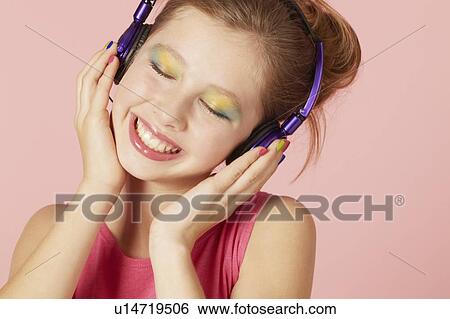 Girl in colorful makeup and headphones View Large Photo Image Stock Photograph - Girl in colorful makeup and headphones. Fotosearch