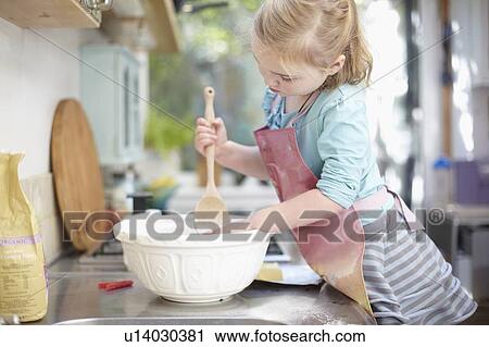 Girl mixing dough in kitchen View Large Photo Image Stock Image - Girl mixing dough in kitchen. Fotosearch