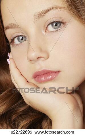 Stock Photography - Girl resting chin in hand. Fotosearch