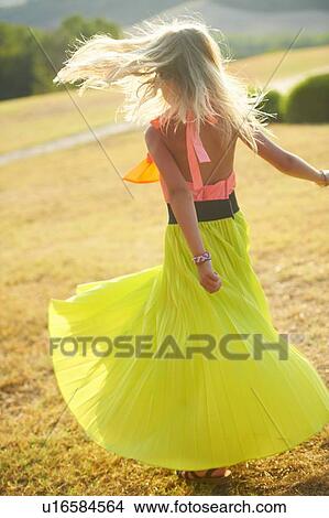 Girl spinning in skirt in field View Large Photo Image Picture - Girl spinning in skirt in field. Fotosearch