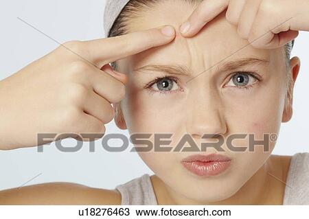 Girl squeezing spot on her face View Large Photo Image Stock Image - Girl squeezing spot on her face. Fotosearch
