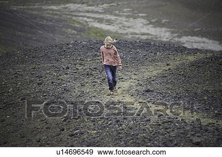 Girl walking in rocky landscape View Large Photo Image Stock Photo - Girl walking in rocky landscape. Fotosearch