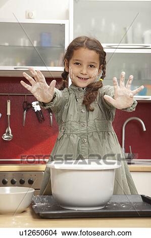 Girl with sticky hands in kitchen View Large Photo Image Picture - Girl with sticky hands in kitchen. Fotosearch