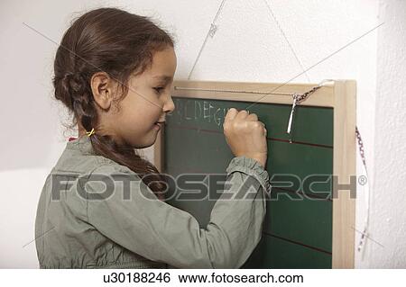 Girl writing on small chalkboard View Large Photo Image Stock Photograph - Girl writing on small chalkboard. Fotosearch