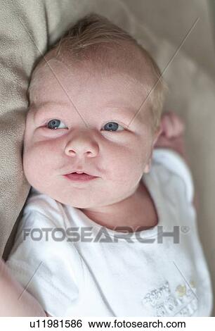Stock Photograph - Infant boy laying on pillow. Fotosearch