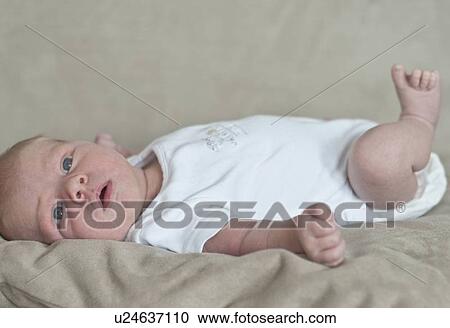 Infant boy laying on sofa View Large Photo Image Stock Image - Infant boy laying on sofa. Fotosearch