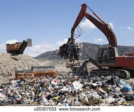Machinery grabbing waste in landfill View Large Photo Image Stock Image - Machinery grabbing waste in landfill. Fotosearch