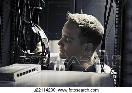 Man working in server room View Large Photo Image Stock Image - Man working in server room. Fotosearch