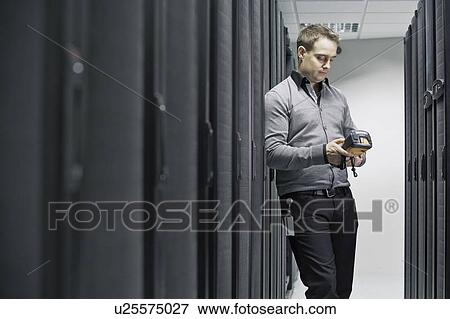 Stock Photo - Man working in server room. Fotosearch