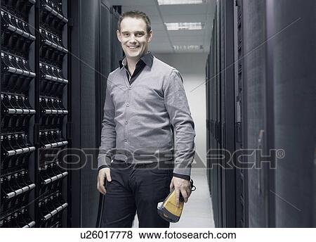 Stock Photo - Man working in server room. Fotosearch