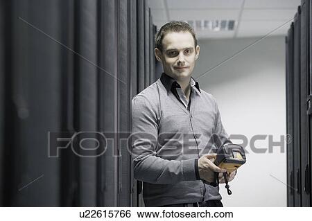 Stock Photograph - Man working in server room. Fotosearch