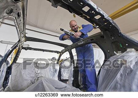 Mechanic working on car in garage View Large Photo Image Stock Photo - Mechanic working on car in garage. Fotosearch