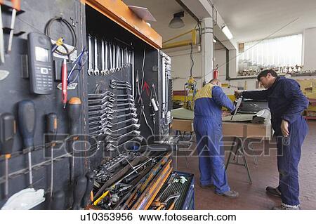 Mechanics working in garage View Large Photo Image Stock Photograph - Mechanics working in garage. Fotosearch