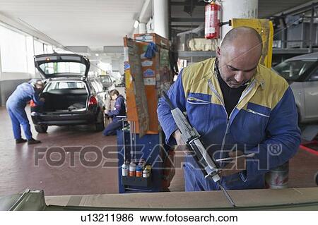 Mechanics working in garage View Large Photo Image Stock Photograph - Mechanics working in garage. Fotosearch