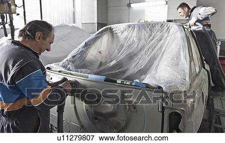 Mechanics working on car in garage View Large Photo Image Stock Photo - Mechanics working on car in garage. Fotosearch
