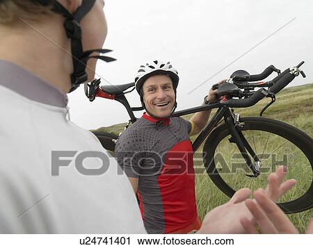 Men with bicycle on rural road View Large Photo Image Stock Image - Men with bicycle on rural road. Fotosearch