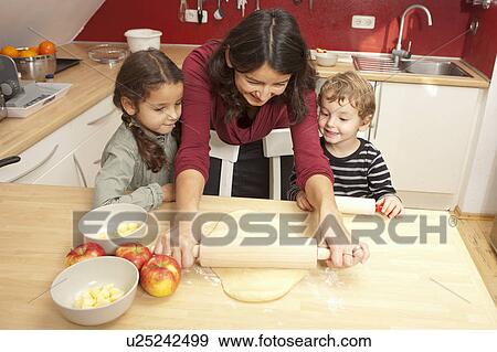 Mother and children baking together View Large Photo Image Stock Photo - Mother and children baking together. Fotosearch