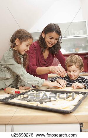 Mother and children baking together View Large Photo Image Stock Photograph - Mother and children baking together. Fotosearch