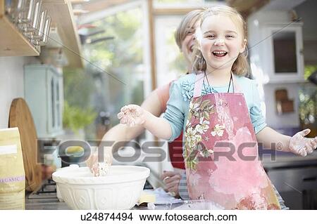 Mother and daughter baking together View Large Photo Image Picture - Mother and daughter baking together. Fotosearch