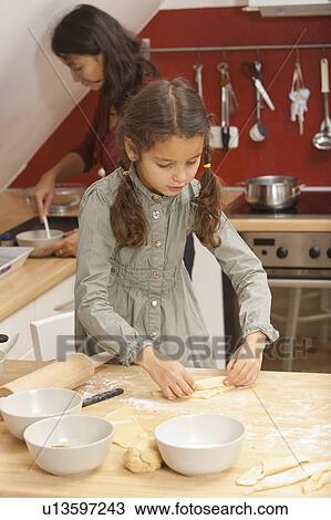 Mother and daughter baking together View Large Photo Image Stock Image - Mother and daughter baking together. Fotosearch