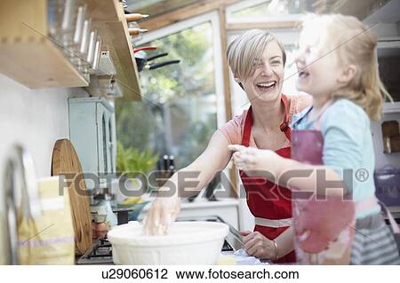Mother and daughter baking together View Large Photo Image Stock Image - Mother and daughter baking together. Fotosearch