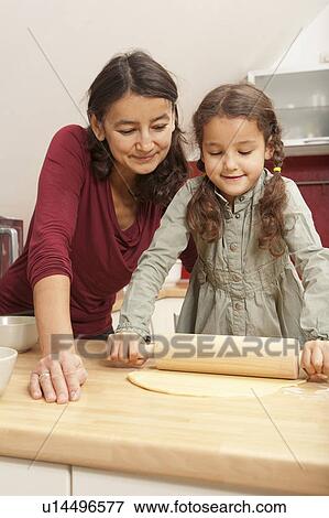 Mother and daughter baking together View Large Photo Image Stock Photo - Mother and daughter baking together. Fotosearch