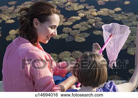 Mother and daughter fishing with net View Large Photo Image Stock Photograph - Mother and daughter fishing with net. Fotosearch