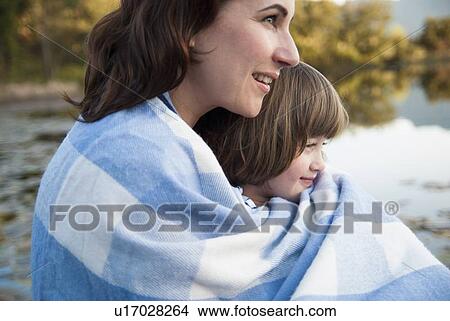 Mother and daughter wrapped in blanket View Large Photo Image Picture - Mother and daughter wrapped in blanket. Fotosearch