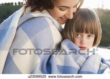 Mother and daughter wrapped in blanket View Large Photo Image Stock Image - Mother and daughter wrapped in blanket. Fotosearch