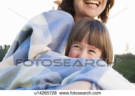 Mother and daughter wrapped in blanket View Large Photo Image Stock Photo - Mother and daughter wrapped in blanket. Fotosearch