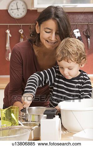 Stock Photography - Mother and son cooking in kitchen. Fotosearch