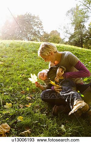 Mother and son playing in park View Large Photo Image Stock Image - Mother and son playing in park. Fotosearch