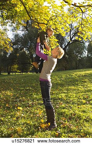 Mother and son playing in park View Large Photo Image Stock Image - Mother and son playing in park. Fotosearch