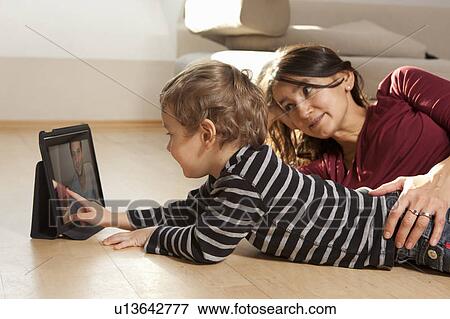 Stock Photo - Mother and son video chatting. Fotosearch